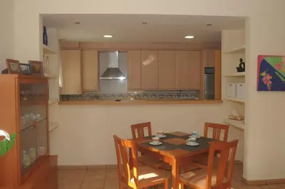 a kitchen with a table and chairs in a room at Apartaments Villa Conchi in Sitges