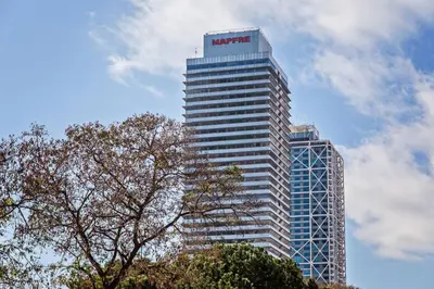 a tall building with a nike sign on it at Sweett - Bogatell Beach in Barcelona