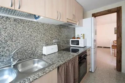a kitchen with a sink and a microwave at Apartments Mo in Monistrol