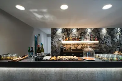 a dining room with two tables and a fish tank at Catalonia Magdalenes in Barcelona
