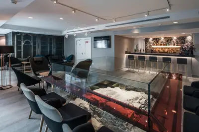 a dining room with a glass table and chairs at Catalonia Magdalenes in Barcelona