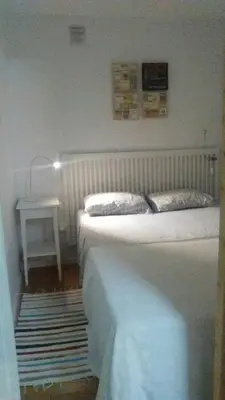 a bedroom with two beds and a table with a lamp at Apartment Aloha Sitges in Sitges