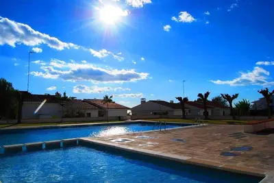 a swimming pool in a villa with a blue sky at Apartment Aloha Sitges in Sitges
