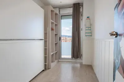 a room with a hallway with a door and a window at Enjoybcn Marina Apartment in Barcelona