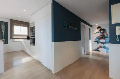 a kitchen with a wall with a movie poster on it at Enjoybcn Marina Apartment in Barcelona