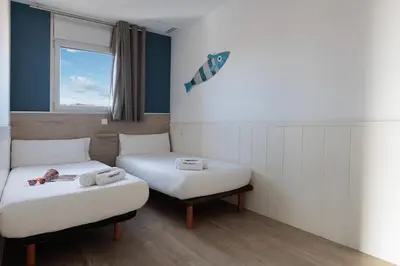 a hospital room with two beds and a window at Enjoybcn Marina Apartment in Barcelona