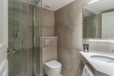 a bathroom with a shower and a toilet and a sink at Enjoybcn Tallers Apartment in Barcelona