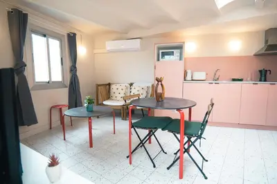 a living room with two tables and a kitchen at Smartr Barcelona Ramblas in Barcelona