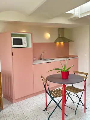 a small kitchen with a table and a microwave at Smartr Barcelona Ramblas in Barcelona