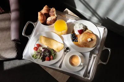 a tray of breakfast foods on a table at Hotel La Pau in Barcelona