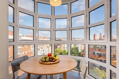 a large room with a table and chairs and windows at Sweett - Villa Olimpica Mediterranean in Barcelona