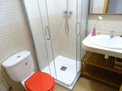 a bathroom with a shower and a toilet and a sink at Apartment Sant Sebastià in Sitges