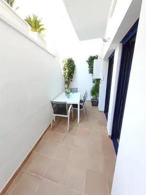 a balcony with a table and chairs in a building at Apartment Sant Sebastià in Sitges