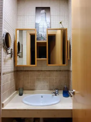 a bathroom with a sink and two mirrors at Apartment Sant Sebastià in Sitges