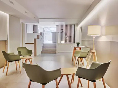 a living room with chairs and a table at Hostal Lami in Esplugues de Llobregat