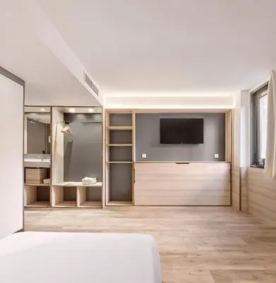 a bedroom with a bed and a flat screen tv at Hostal Lami in Esplugues de Llobregat