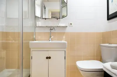 a bathroom with a sink and a toilet and a mirror at Hotel El Call in Barcelona