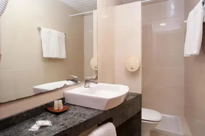 a bathroom with a sink and a toilet and a mirror at Hostal Fernando in Barcelona