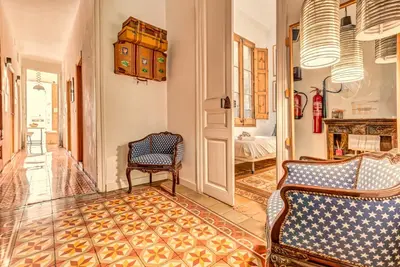 a living room with two chairs and a table at Factory Suites Barcelona in Barcelona