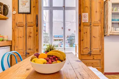 a bowl of fruit sitting on a wooden table at Factory Suites Barcelona in Barcelona
