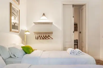 a white room with a bed and a couch at Factory Suites Barcelona in Barcelona