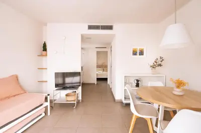 a living room with a couch and a table at Apartamentos Castellmar in Castelldefels