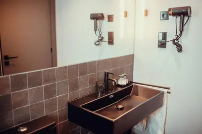 a bathroom with a brown sink and a mirror at Hotel Transit in Barcelona