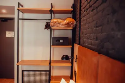 a room with wooden shelves and a wall at Hotel Transit in Barcelona