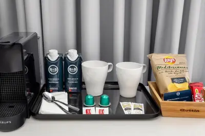a tray with cups and other items on a desk at B&B HOTEL Barcelona Mollet in Mollet del Vallès