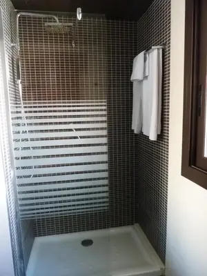 a shower with a glass door in a bathroom at Barcelona House in Barcelona