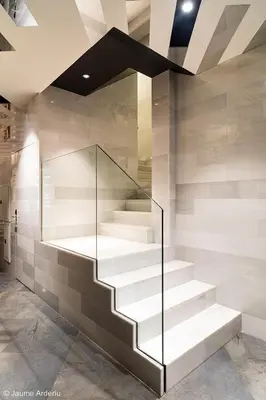 a staircase with glass railing in a building at Barcelona House in Barcelona