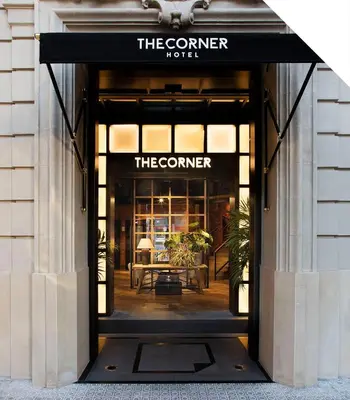 a door to the corner hotel with a table inside at The Corner Hotel in Barcelona