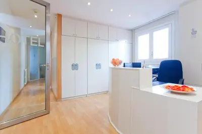 an office with a desk and a chair and a mirror at Hotel Everest in Barcelona