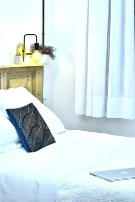 a laptop computer sitting on top of a bed at Hostal Girona in Barcelona
