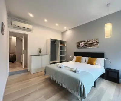a bedroom with a large bed with towels on it at Stay U-nique Apartments Sants in Barcelona