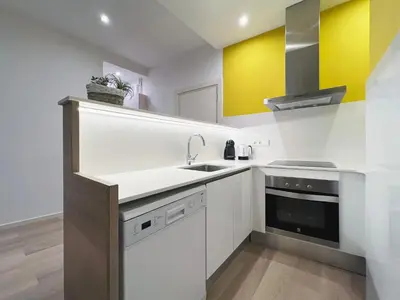 a kitchen with white cabinets and a sink at Stay U-nique Apartments Sants in Barcelona