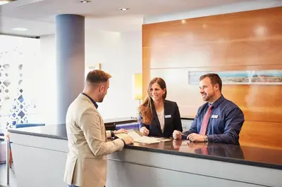 a group of three people sitting at a counter at Barcelona Century Hotel in Barcelona