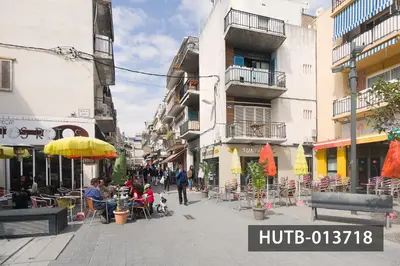 a city street with people sitting at tables and chairs at Blanco Vinyet in Sitges