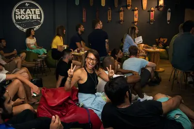 a woman giving the peace sign in a room full of people at Sant Jordi Hostels Sagrada Familia in Barcelona
