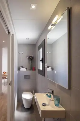 a bathroom with a sink and a toilet and a mirror at Hotel Sagrada Familia Apartments in Barcelona