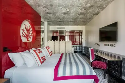 a bedroom with a large bed with two pillows at Room Mate Anna, Barcelona in Barcelona