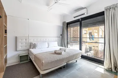 a bedroom with a large bed and a large window at Super central 3BR apartment, spacious and bright in Barcelona