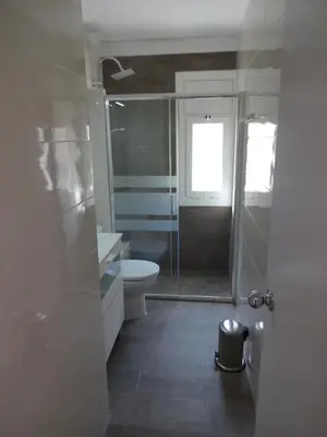 a bathroom with a glass shower and a toilet at Castelldefels Playa in Castelldefels