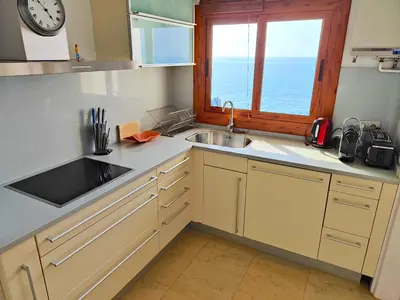 a kitchen with a sink and a window at Sitges Balcony Pool & Seaside Apartment in Sitges