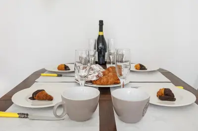 a table with plates of food and wine glasses at Matarolux 6 in Mataró