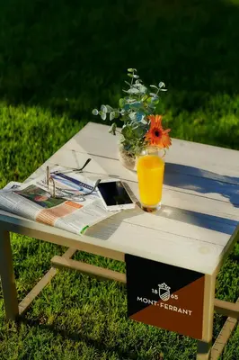 a picnic table with a glass of orange juice on it at Hotel Arrey Alella in Alella