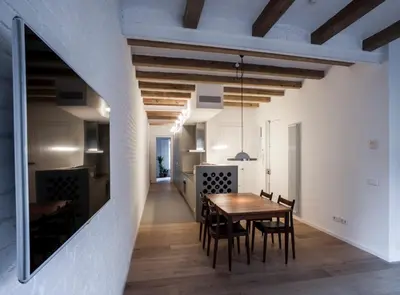 a dining room with a wooden table and chairs at Villaroel · Modern flat in San Antoni in Barcelona