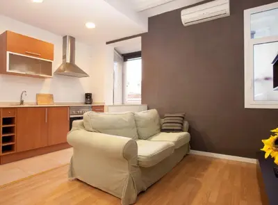 a living room with a couch and a kitchen at Authentic flat2 in Poble sec - Paralelo in Barcelona