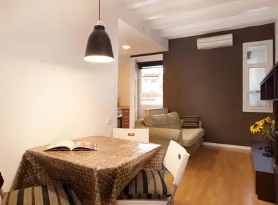 a living room with a table and a couch at Authentic flat2 in Poble sec - Paralelo in Barcelona