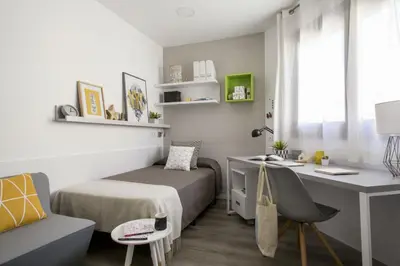 a small bedroom with a bed and a desk at Residencia Universitaria Resa Barcelona Diagonal in Barcelona